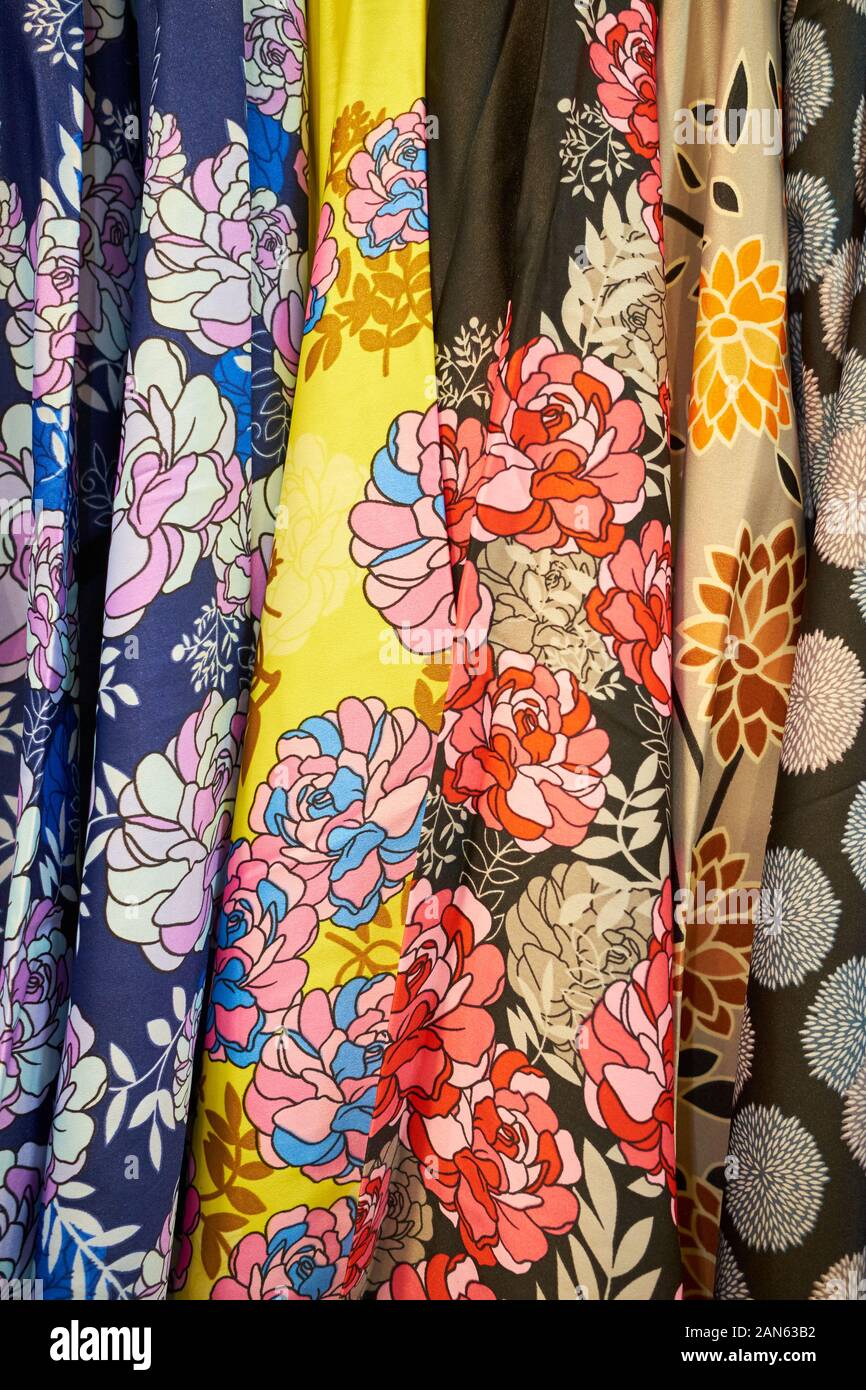 A rack of colorful, loud, traditional Malay flower design fabric