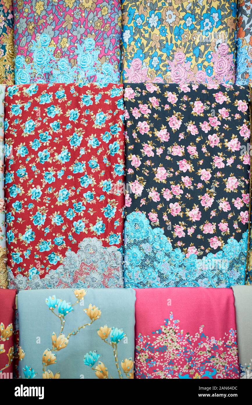 A display of colorful, traditional Malay floral design fabric, textiles