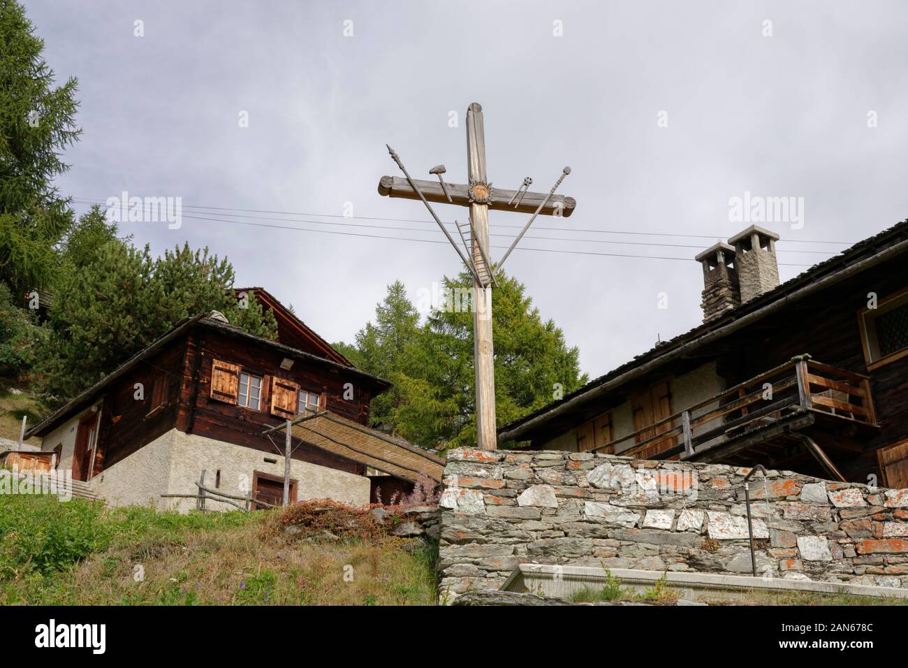 Cross, built in 1930, in the district Tsarine in Chandolin, Val d'Annivers, Canton of Valais, Switzerland Stock Photo