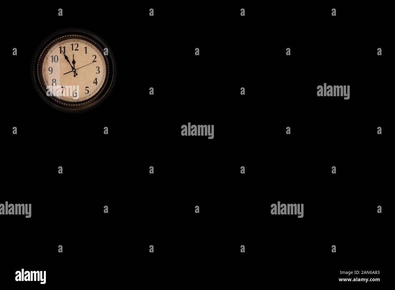 Wall clock hangs on wall Stock Photo