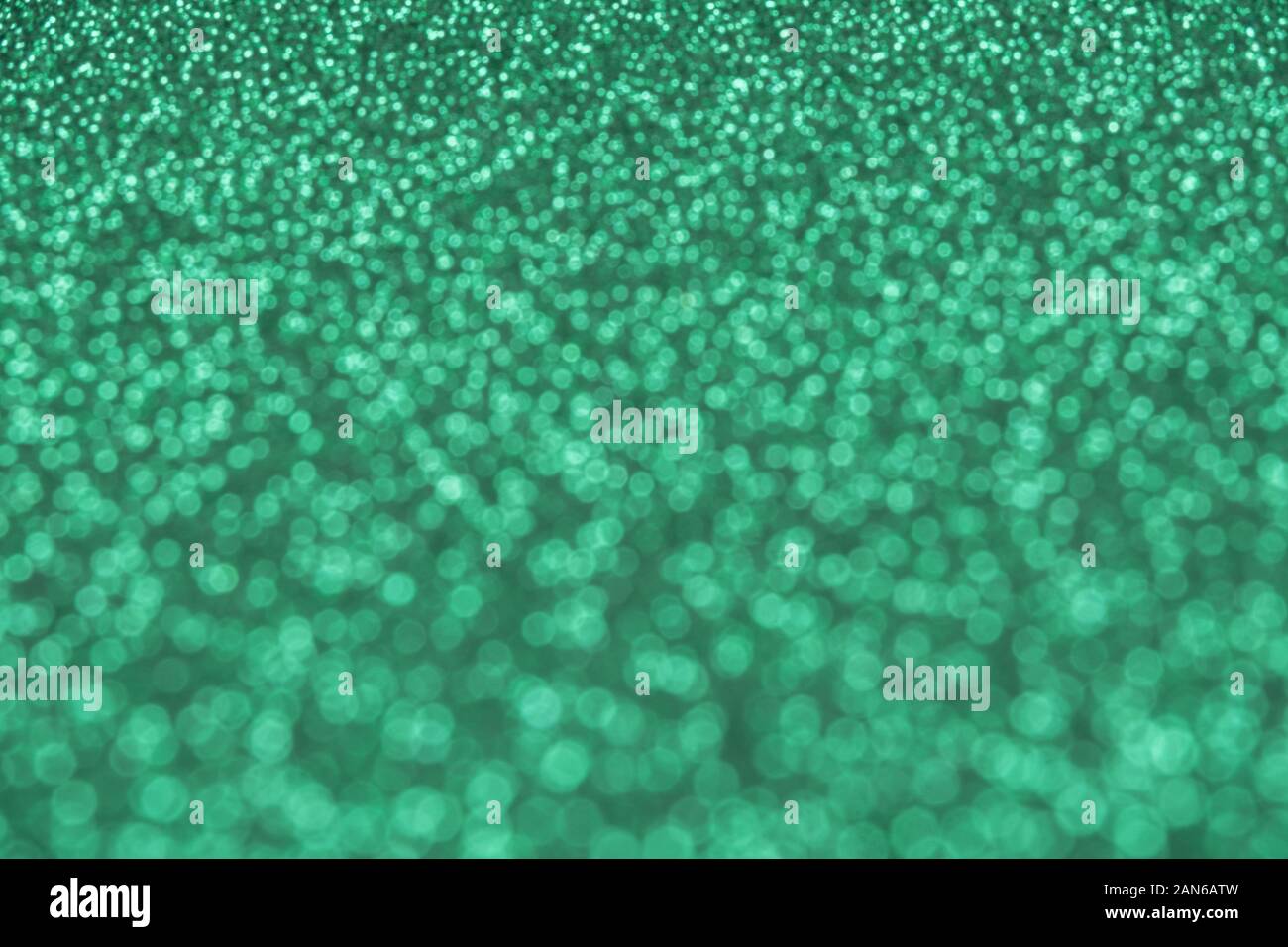 Beautiful green background of unfocused sequins and glitter Stock Photo