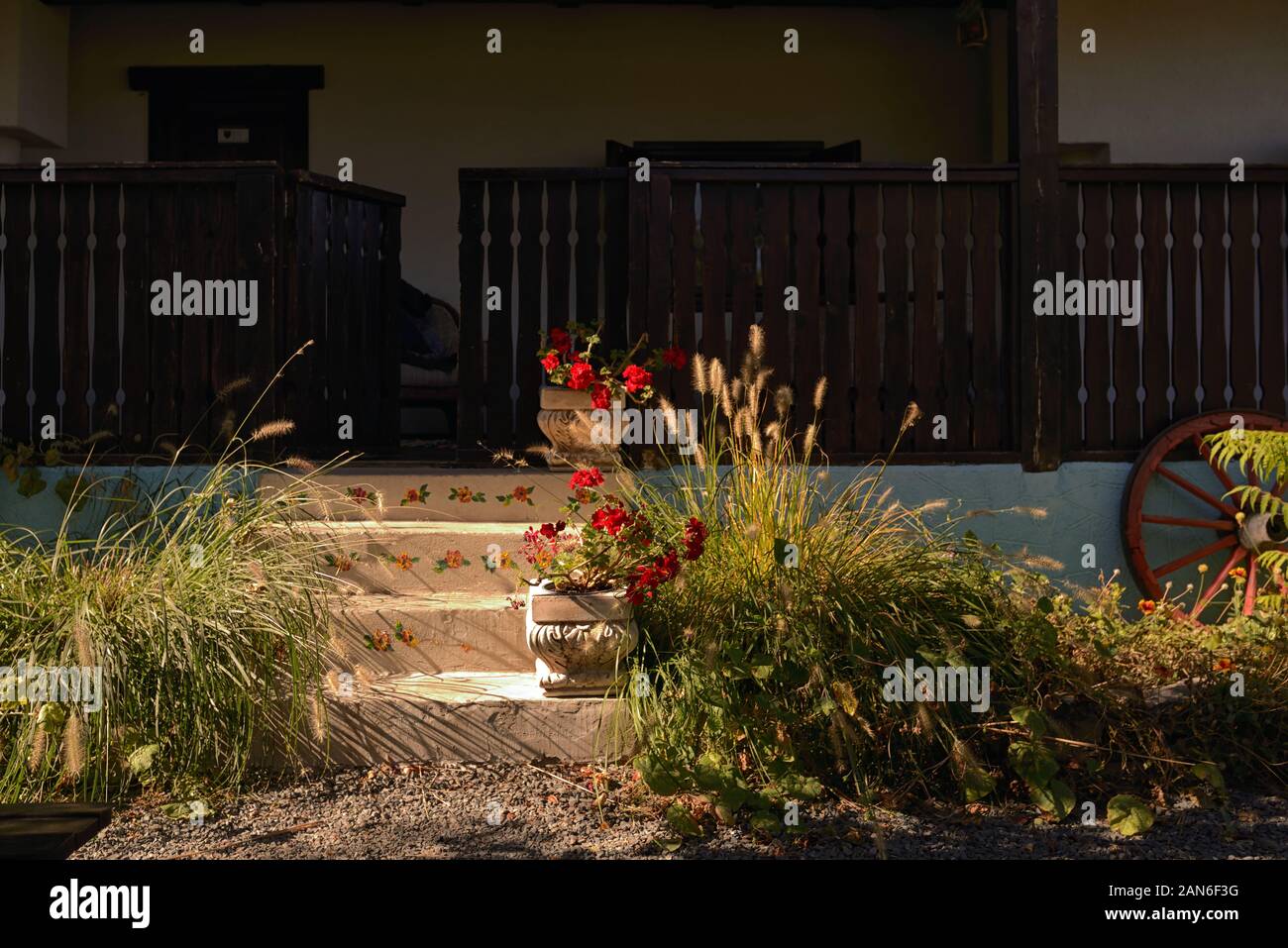 Old Style Rustic House With Laborious Wood Porch Stock Photo