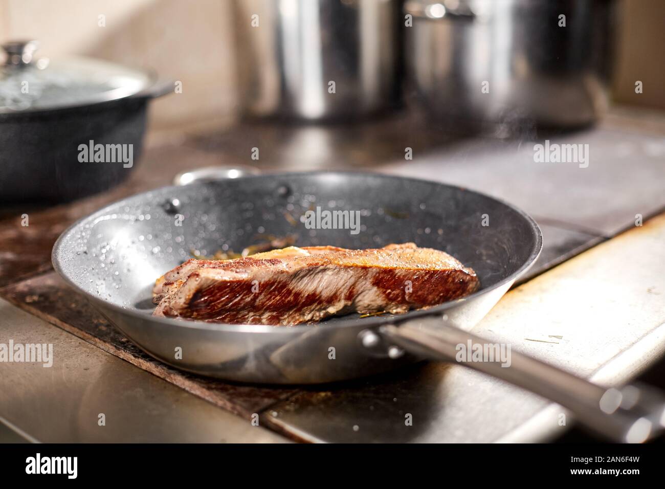 fried ribs of lamb. Cooking with fire in frying pan. Professional chef