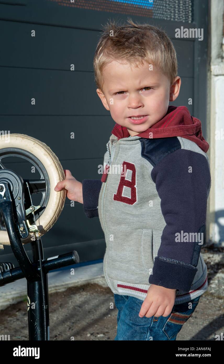 cute child two years old playing with a bicycle Stock Photo Alamy