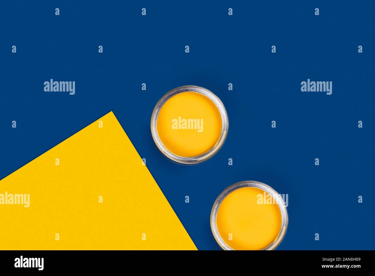 Repair concept. Classic blue and yellow background with two paint cans, diagonal composition. Flat lay, top view, copy space. Stock Photo