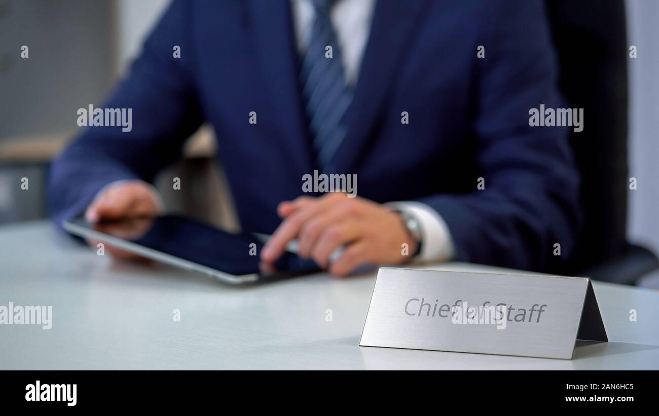 Chief of staff working on tablet pc, managing country presidents schedule Stock Photo