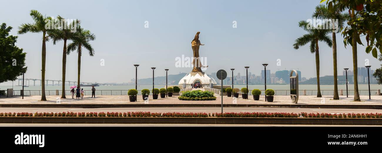 Panorama with Kun Iam statue. Female bodhisattva, commonly known as Guan Yin or Guanyin. The sculpture is made of bronze and 32 meters high (Macao). Stock Photo
