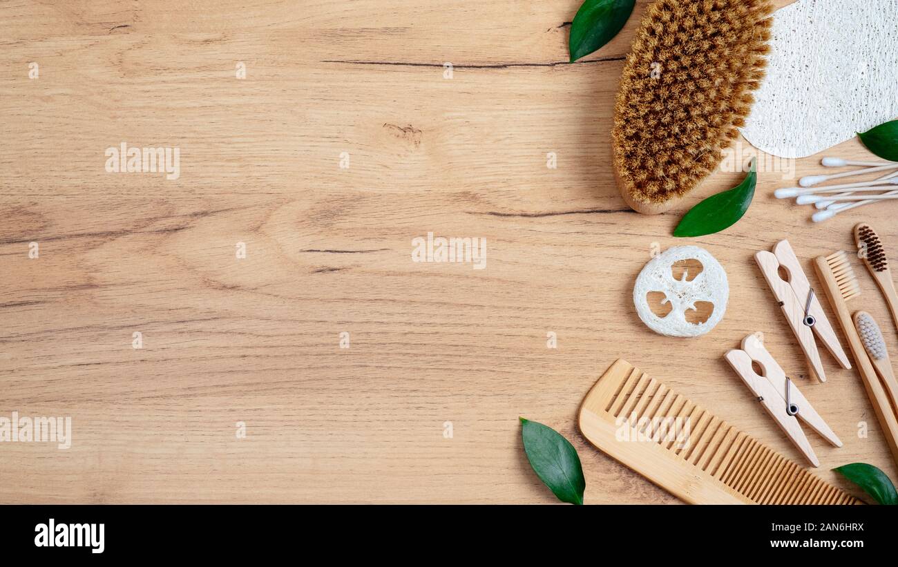 Set of natural ecofriendly bath accessories on wooden table. Top view