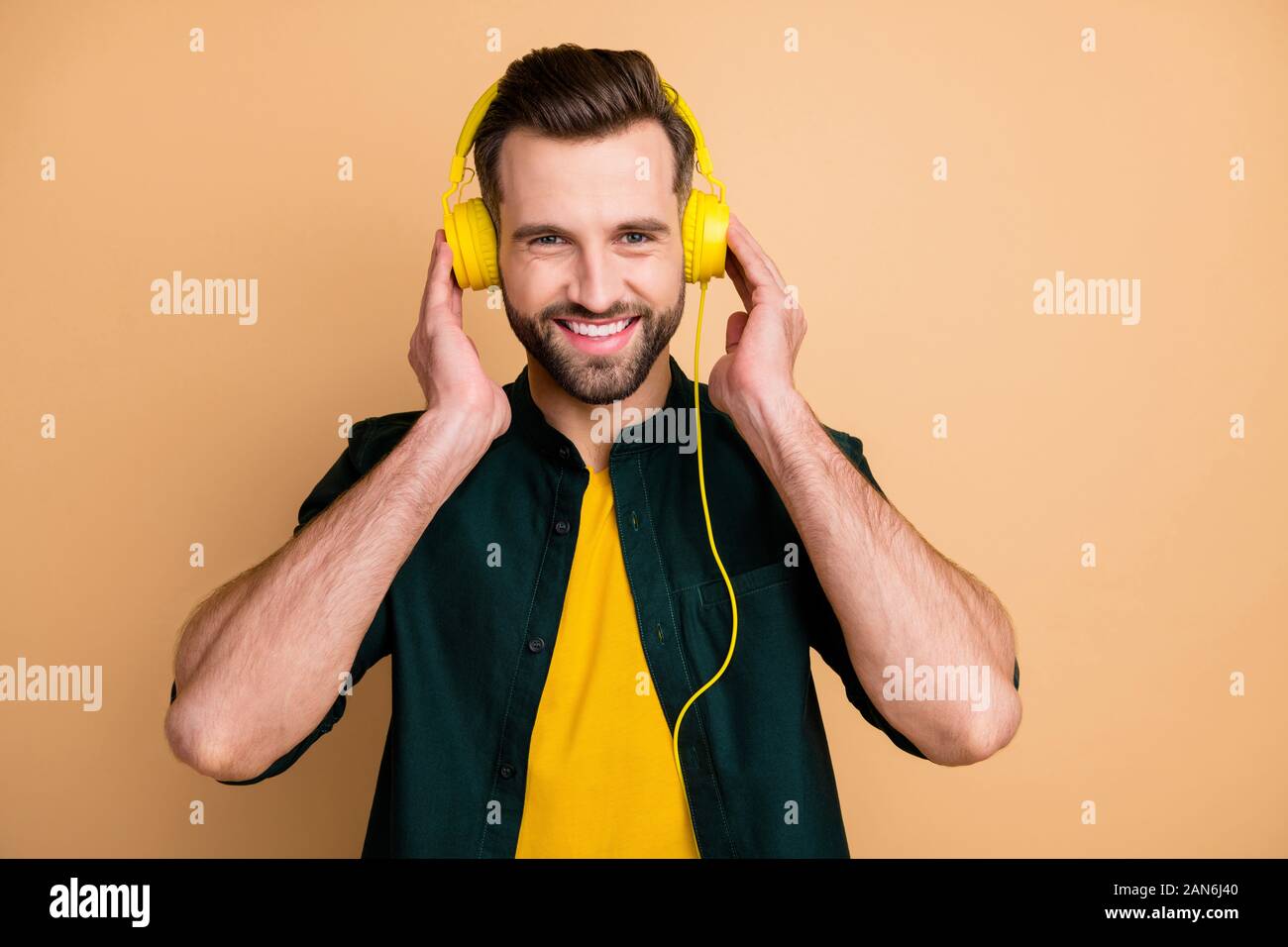 Photo of nice handsome hipster guy holding hands cool modern yellow