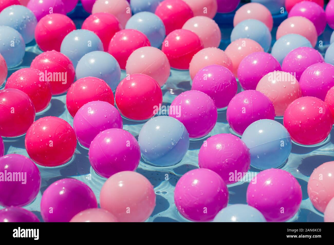 Close up of colorful plastic balls swimming in the water. Concept / abstract for party, being happy, being in a team or diversity. Stock Photo