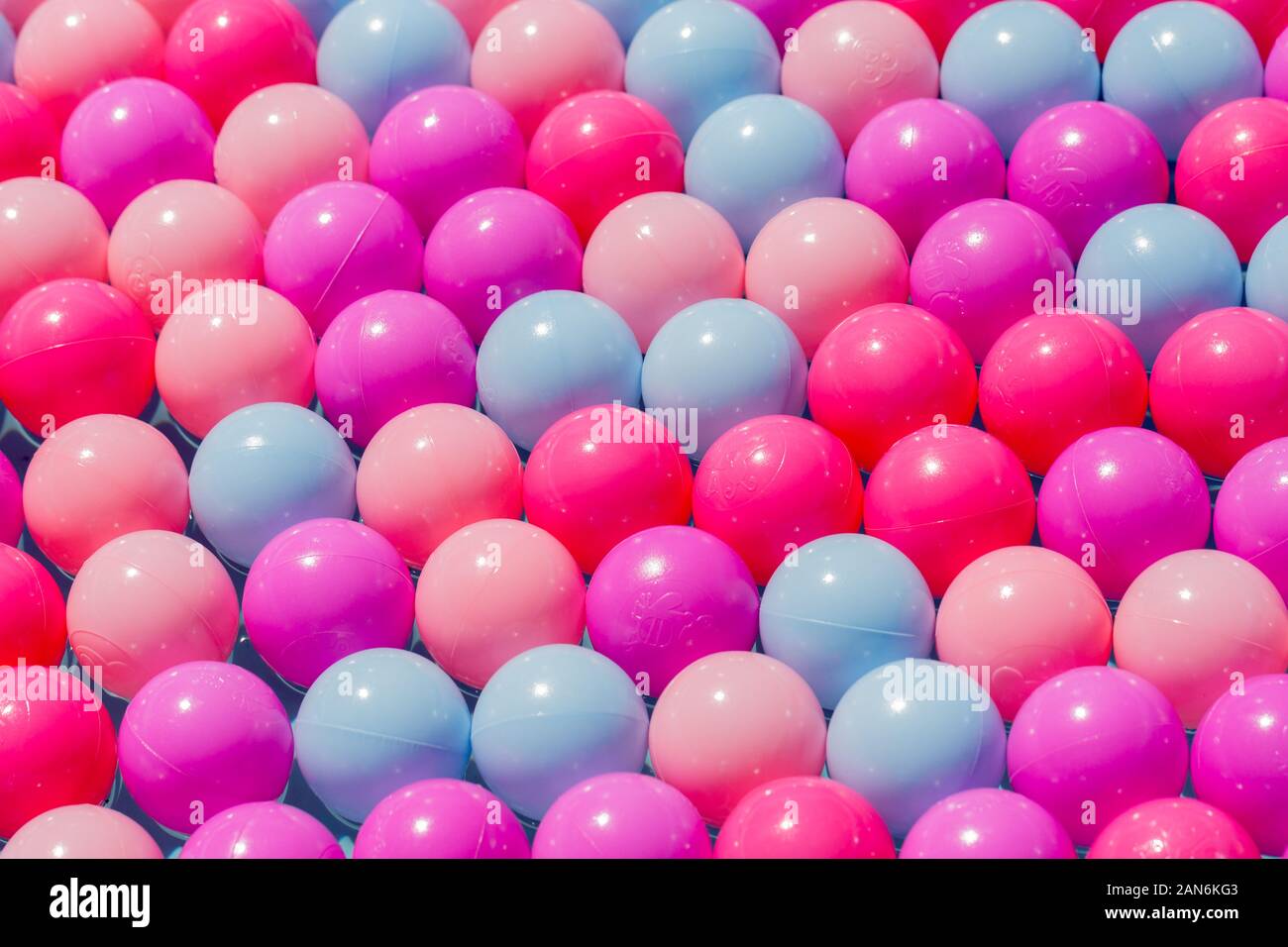 Plastic balls of various colors perfectly line up in several rows. Concept. Symbol for unity, perfection, diversity, alginment, being different. Stock Photo