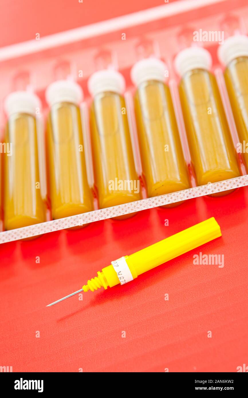Medical blisters and yellow needle isolated in red Stock Photo Alamy