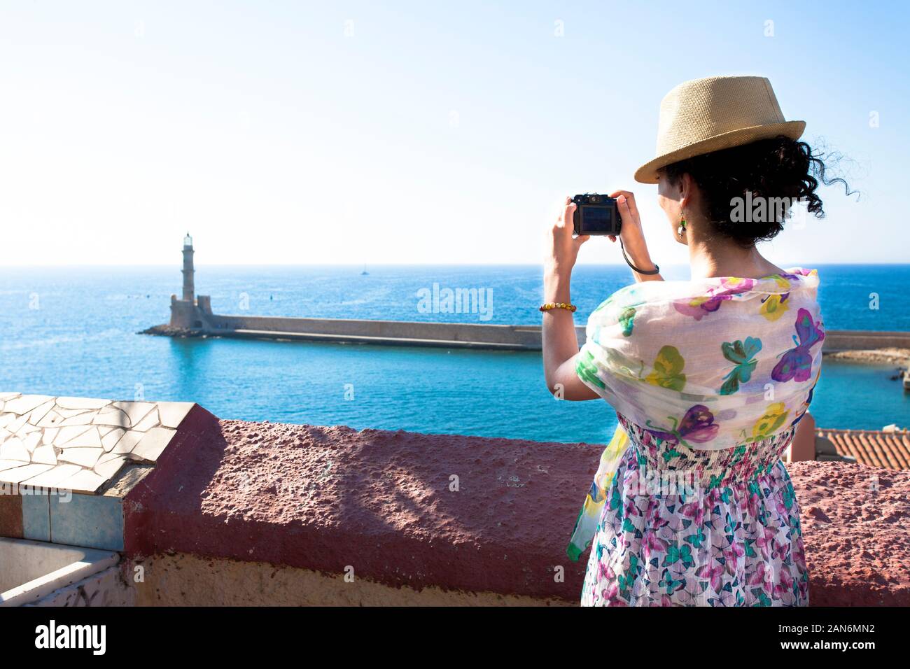 Attractive middle-aged caucasian brunette woman in casual dress photographing during holidays in Greece Stock Photo