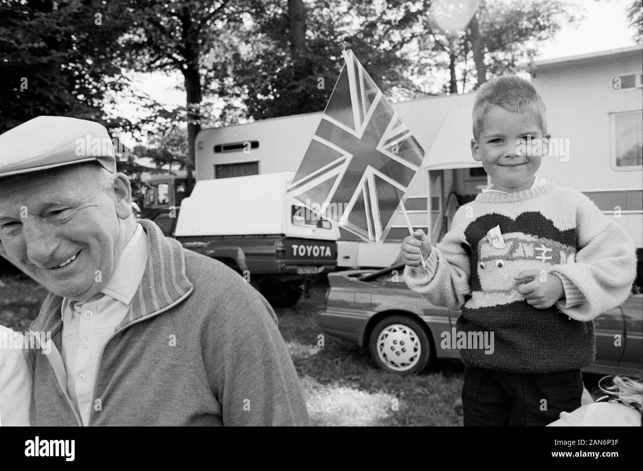 Man with flat cap and child with Union Jack with Toyota Car, Keighley Gala, West Yorkshire 1990. Stock Photo