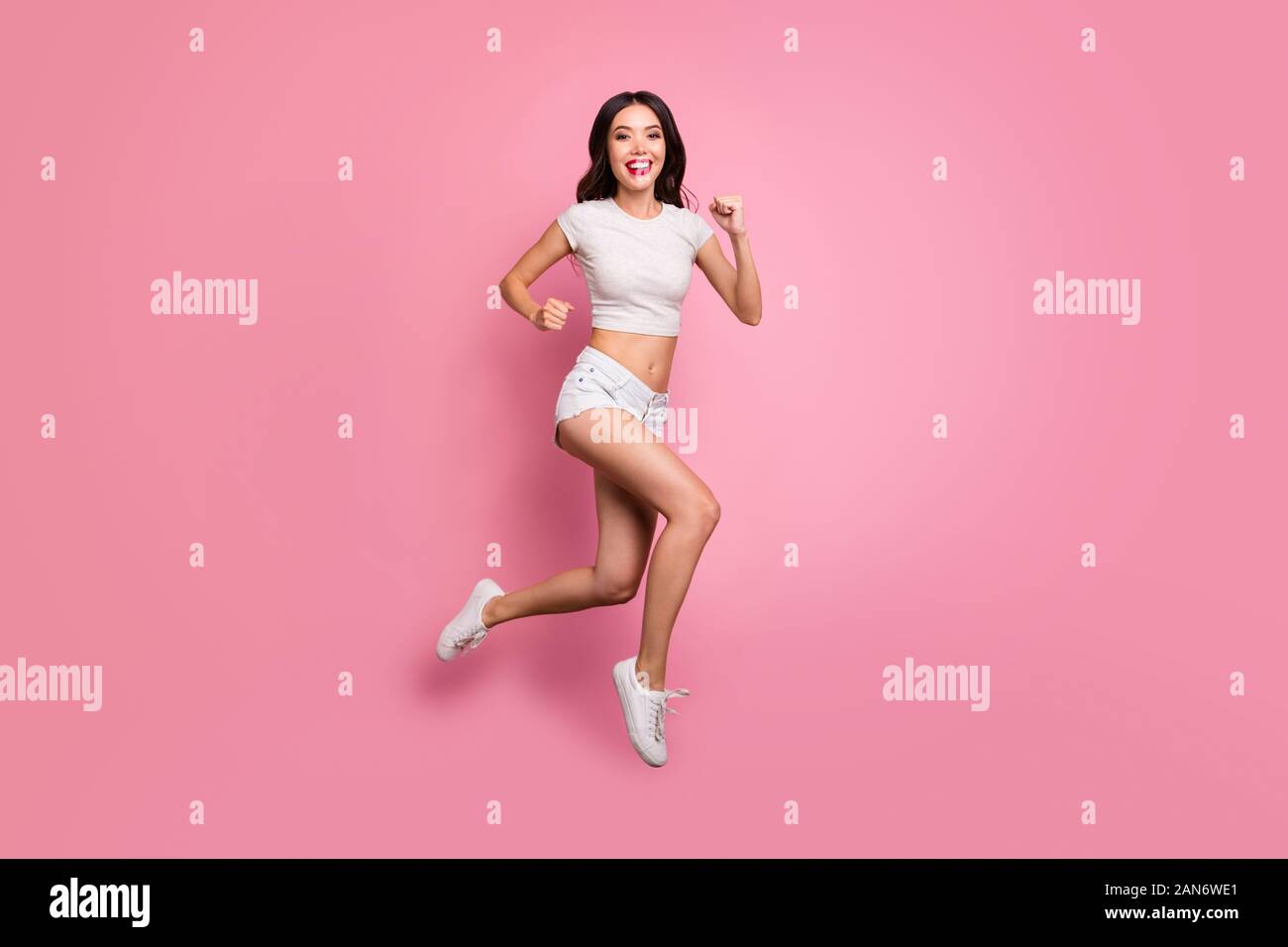 Full length body size view of her she nice attractive lovely charming sportive cheerful cheery wavy-haired girl jumping running having fun motion Stock Photo