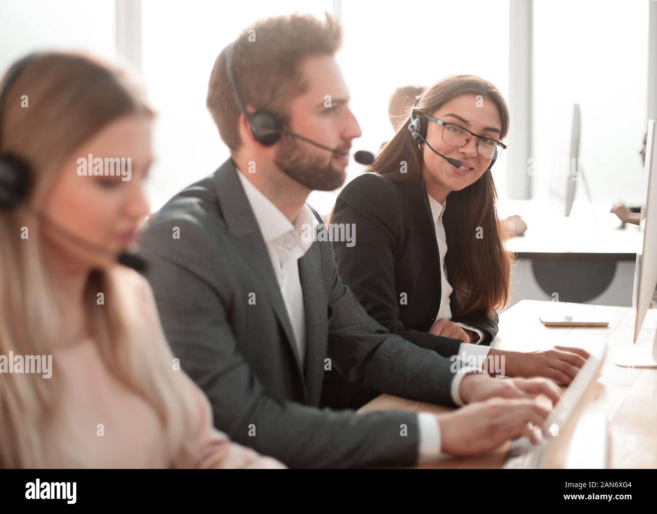 call center employees work with clients in a modern office Stock Photo