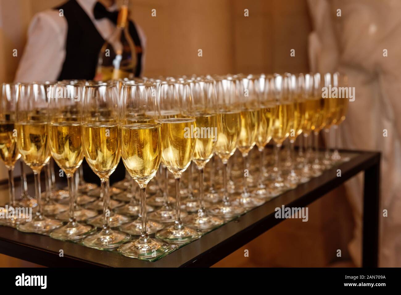 Lots of champagne glasses. Alcoholic drinks at the event. Sparkling