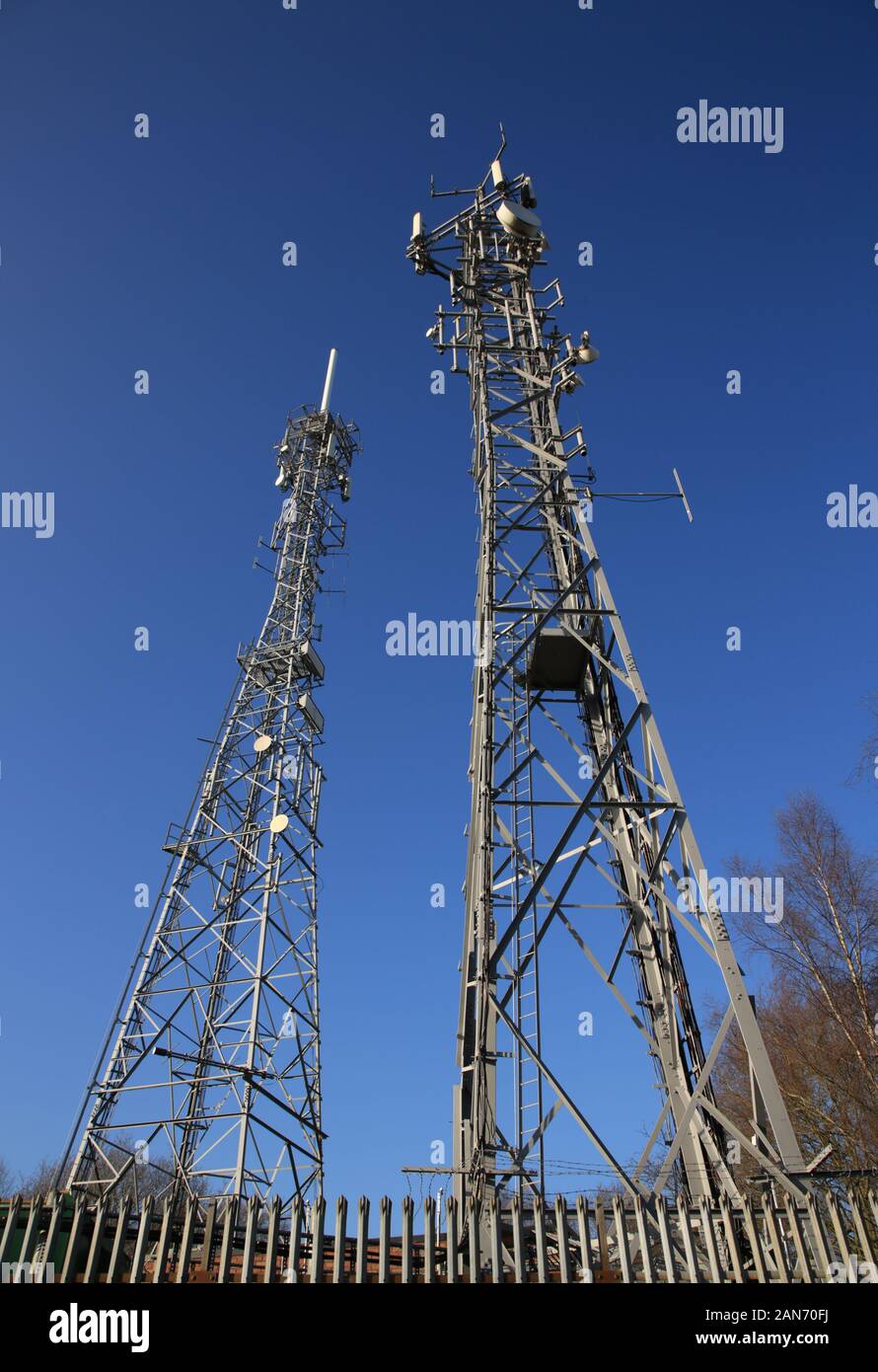 Telecommunication towers against a blue sky. Stock Photo