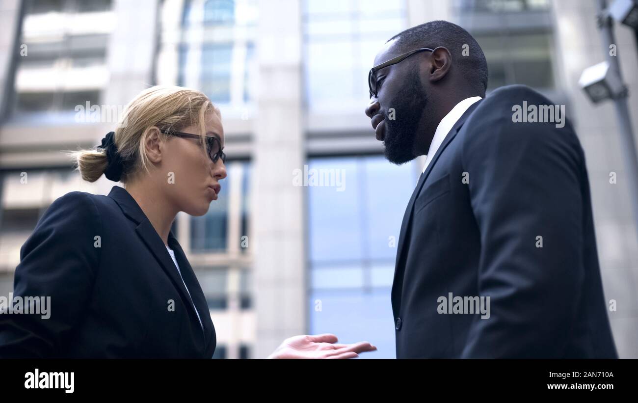 Female boss scolding subordinate, employee justifying himself, business ethics Stock Photo