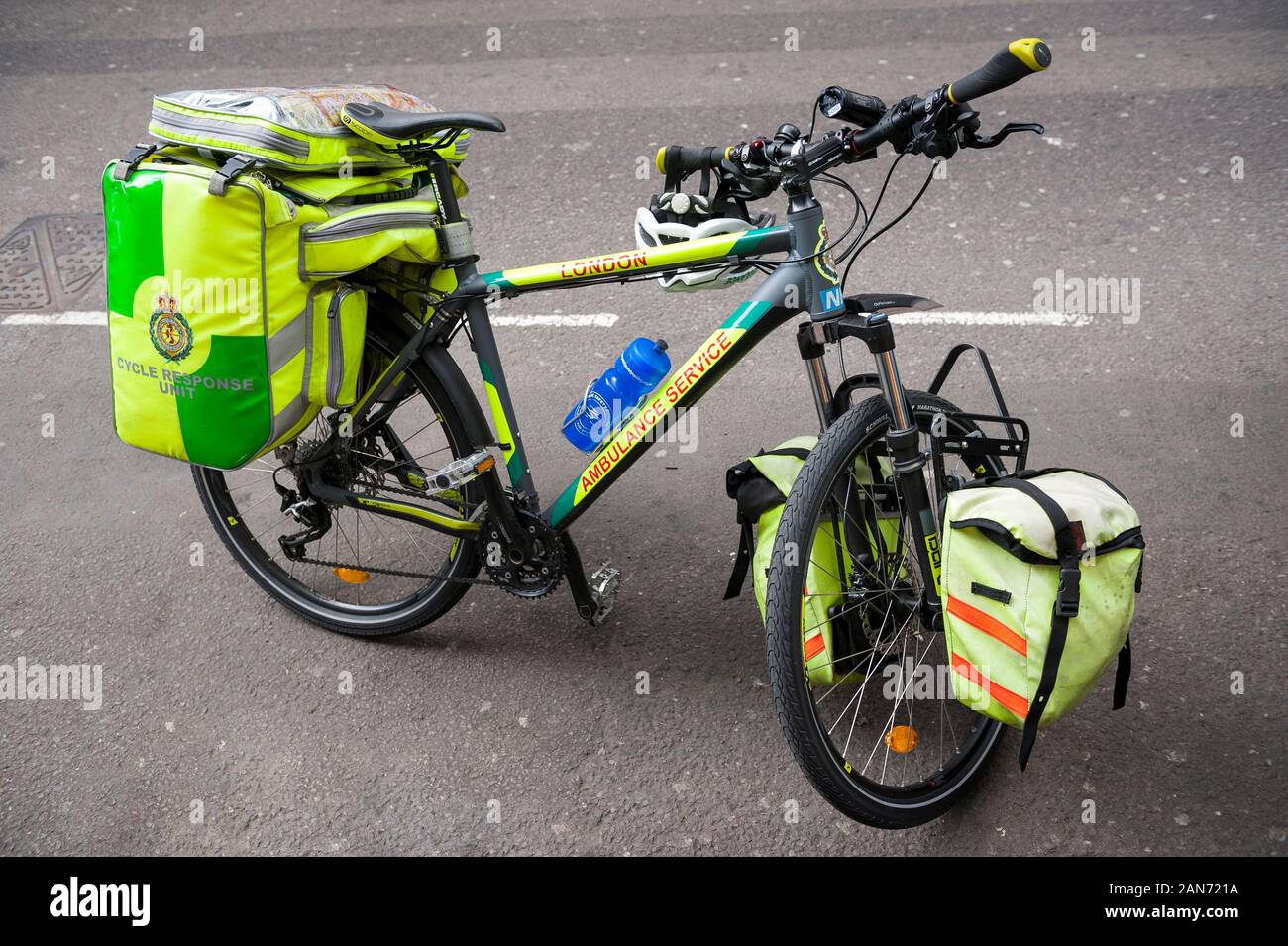 LONDON - JUNE 20, 2012: Ambulance Cycle Response bicycle stands parked with a kit that includes a defibrillator and oxygen. Stock Photo