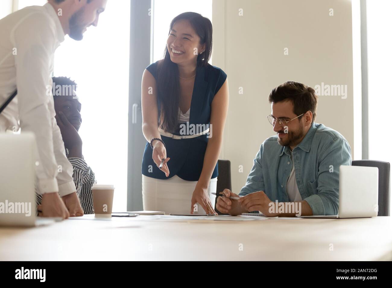 Smiling multiethnic employees have fun brainstorming at meeting Stock ...