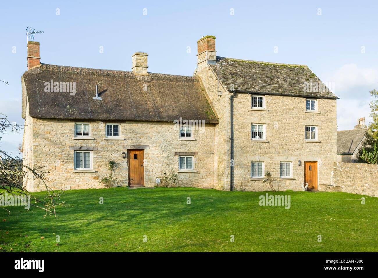 OXFORD, UK - January 03, 2020. Exterior of a large thatched Cotswold stone cottage in Oxfordshire, UK Stock Photo