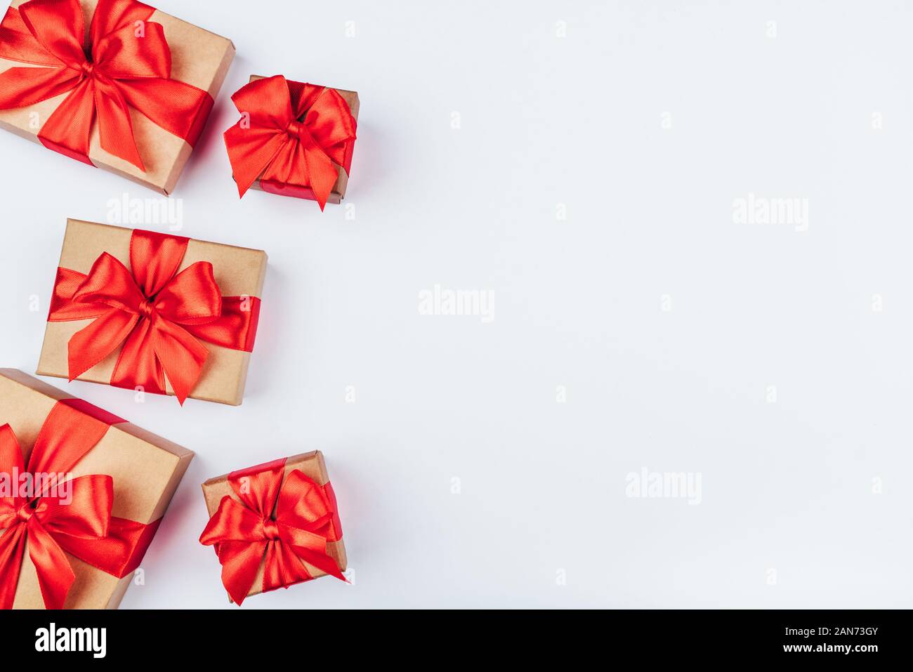 Frame of cardboard gift boxes with red bows Stock Photo - Alamy
