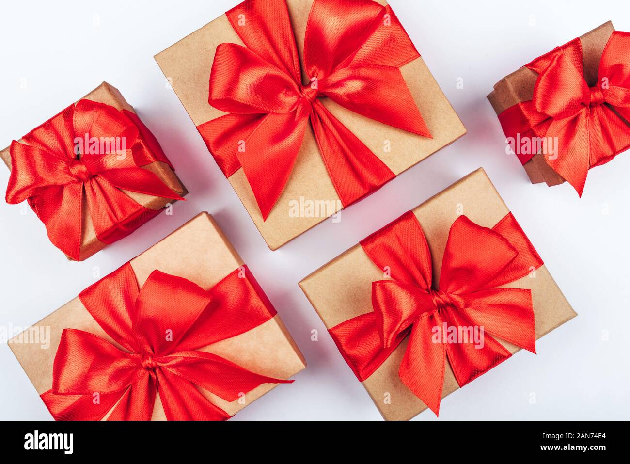 Cardboard gift boxes with red bows on white background. Stock Photo