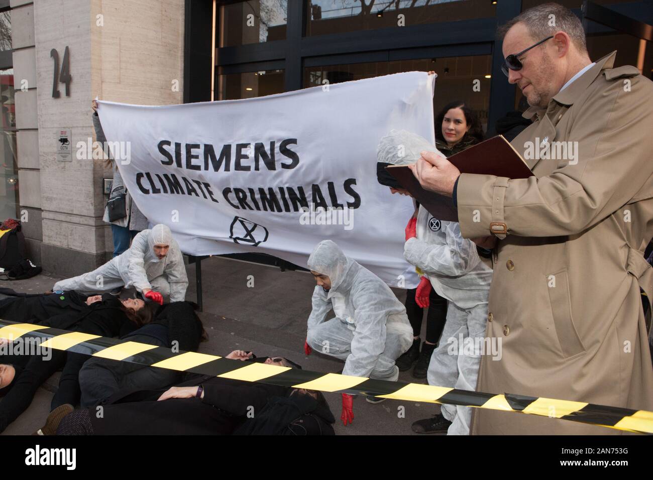 London, UK: 16th Jan 2020. Extinction Rebellion staged a die-in, complete with a detective and team of forensic officers, outside Siemens London headquarters because of their involvement in the Adani open-cast coal mine in Australia, despite claiming to be aiming to go carbon neutral, against the wishes of indeginous peoples, and in the context of Australia's terrible bushfires. Credit: Anna Watson/Alamy Live News Stock Photo
