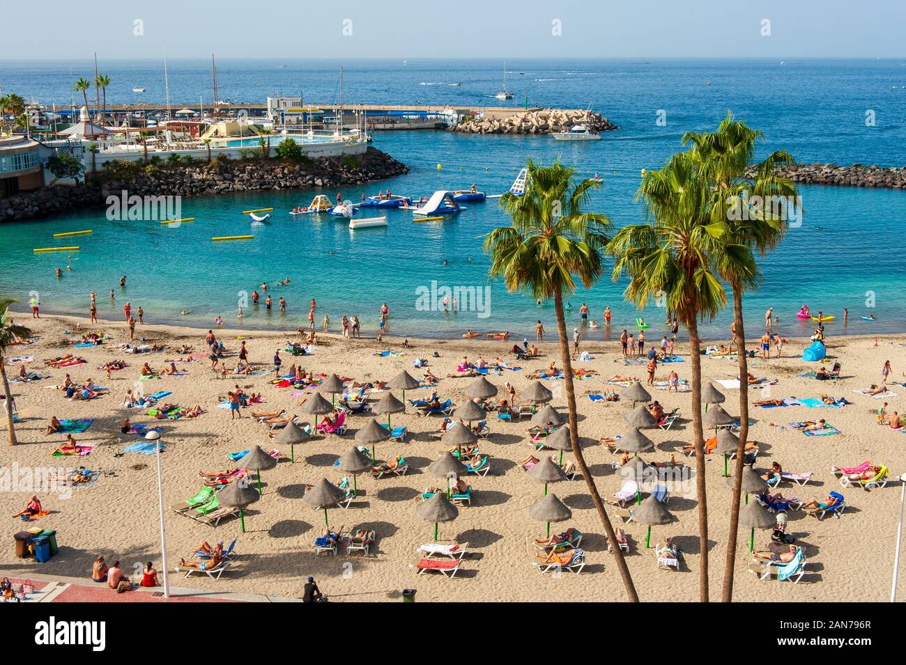 CANARY ISLAND TENERIFE, SPAIN - 26 DEC, 2019: Tourists are relaxing on playa la pinta puerto colon. A very popular beach near the city of San Eugenio. Stock Photo