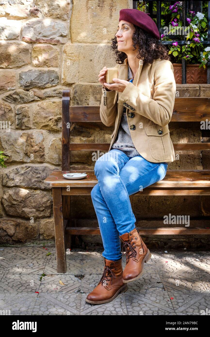 White woman in casual dress enjoying her coffee outside Stock Photo