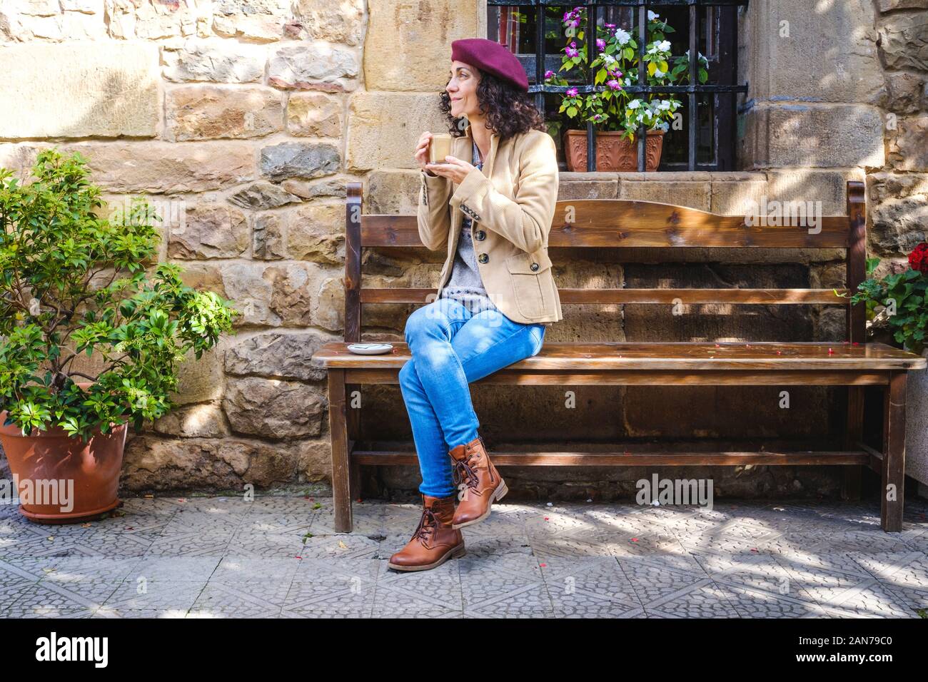 White woman in casual dress enjoying her coffee outside Stock Photo