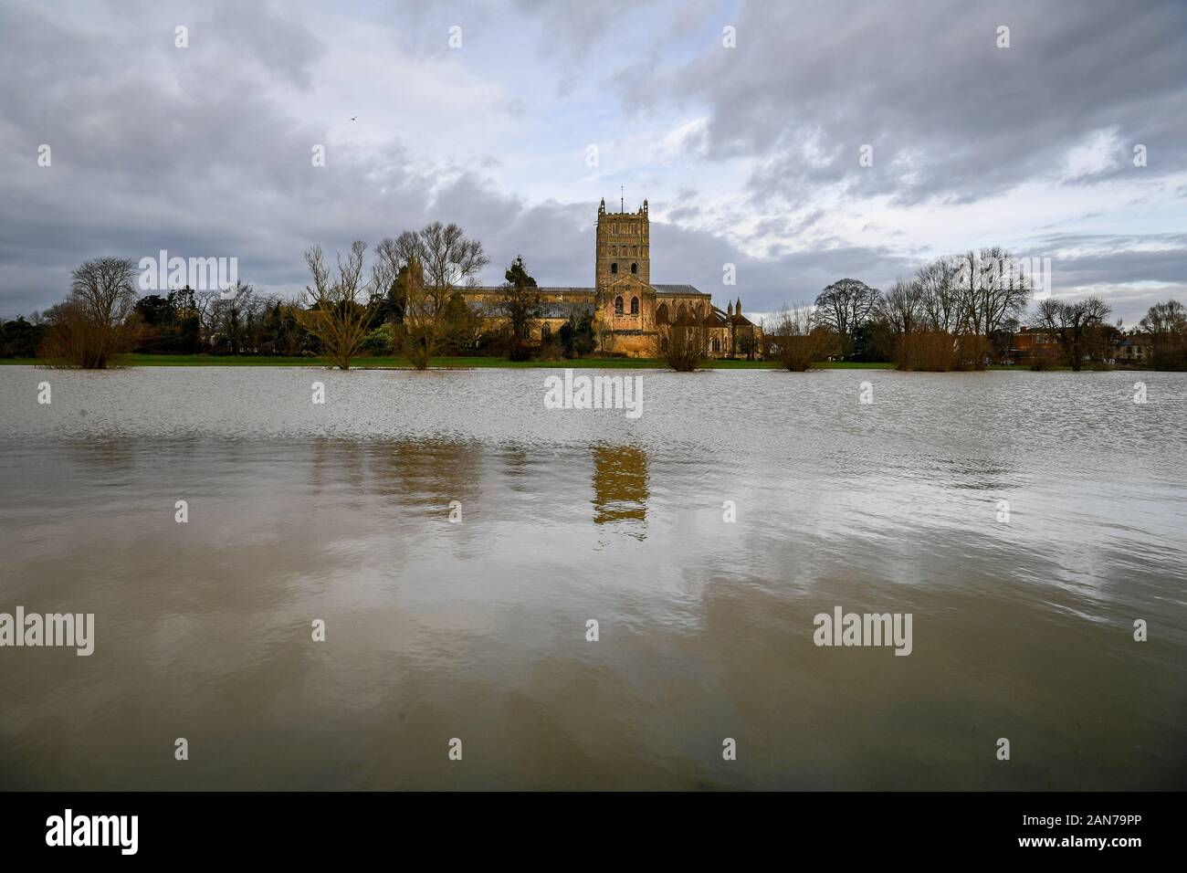 Tewkesbury Abbey, Gloucestershire, sits above flood water after storms and heavy rain across the UK. Stock Photo