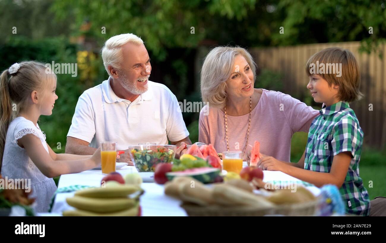 Grandparents and grandchildren having dinner, spending weekend together, cottage Stock Photo Alamy