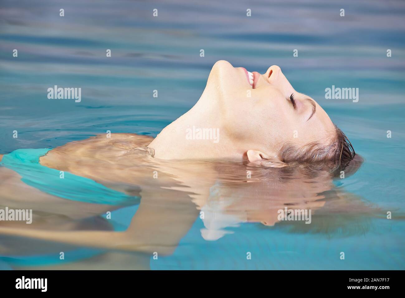 Laughing woman relaxing in the water in a swimming pool Stock Photo - Alamy