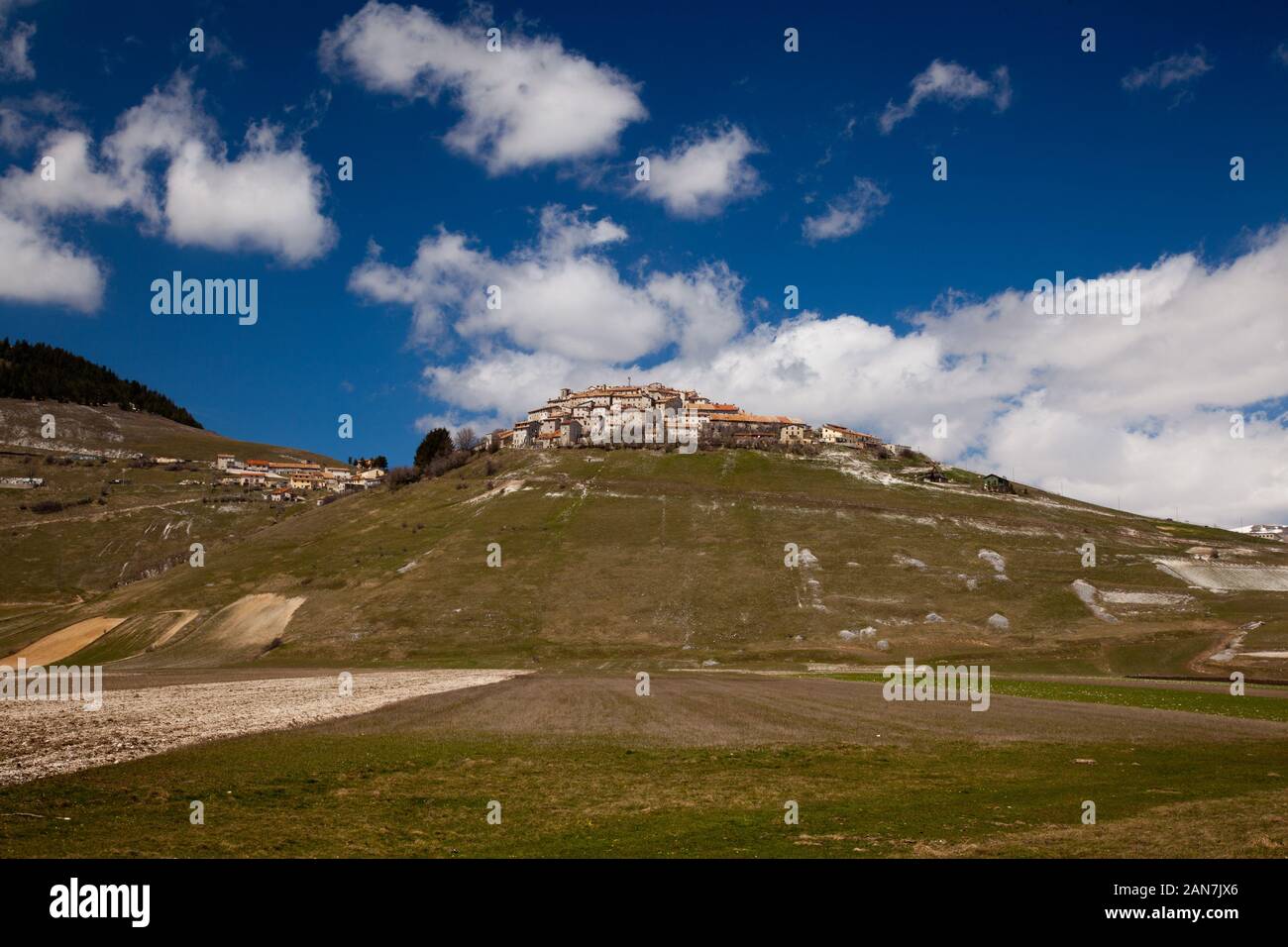 Castelluccio, the highest village in the Apennines perched above the Piano Grande in spring sunshine (pre 2016/7 earthquakes) Stock Photo