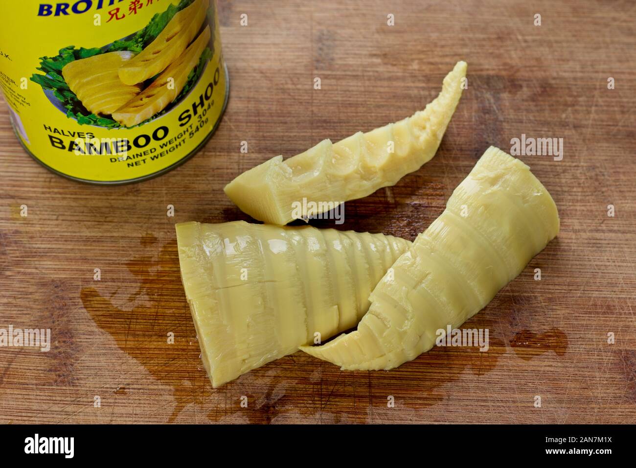 Tin of edible bamboo shoots on a wooden chopping board Stock Photo Alamy
