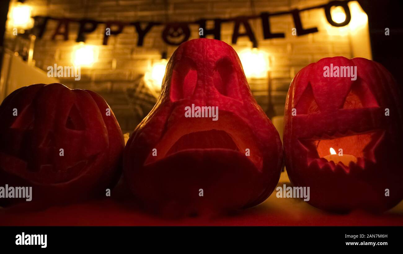 Carved Pumpkins, Smiling, on a Table Out of Doors Facing and Side