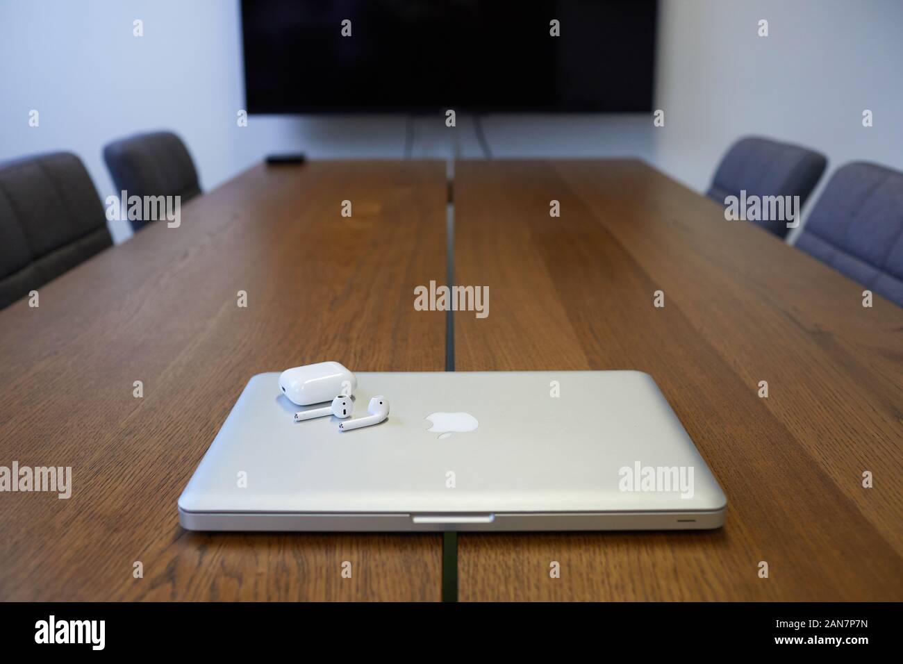 MacBook Pro with Apple EarPods in a board room location Stock Photo - Alamy