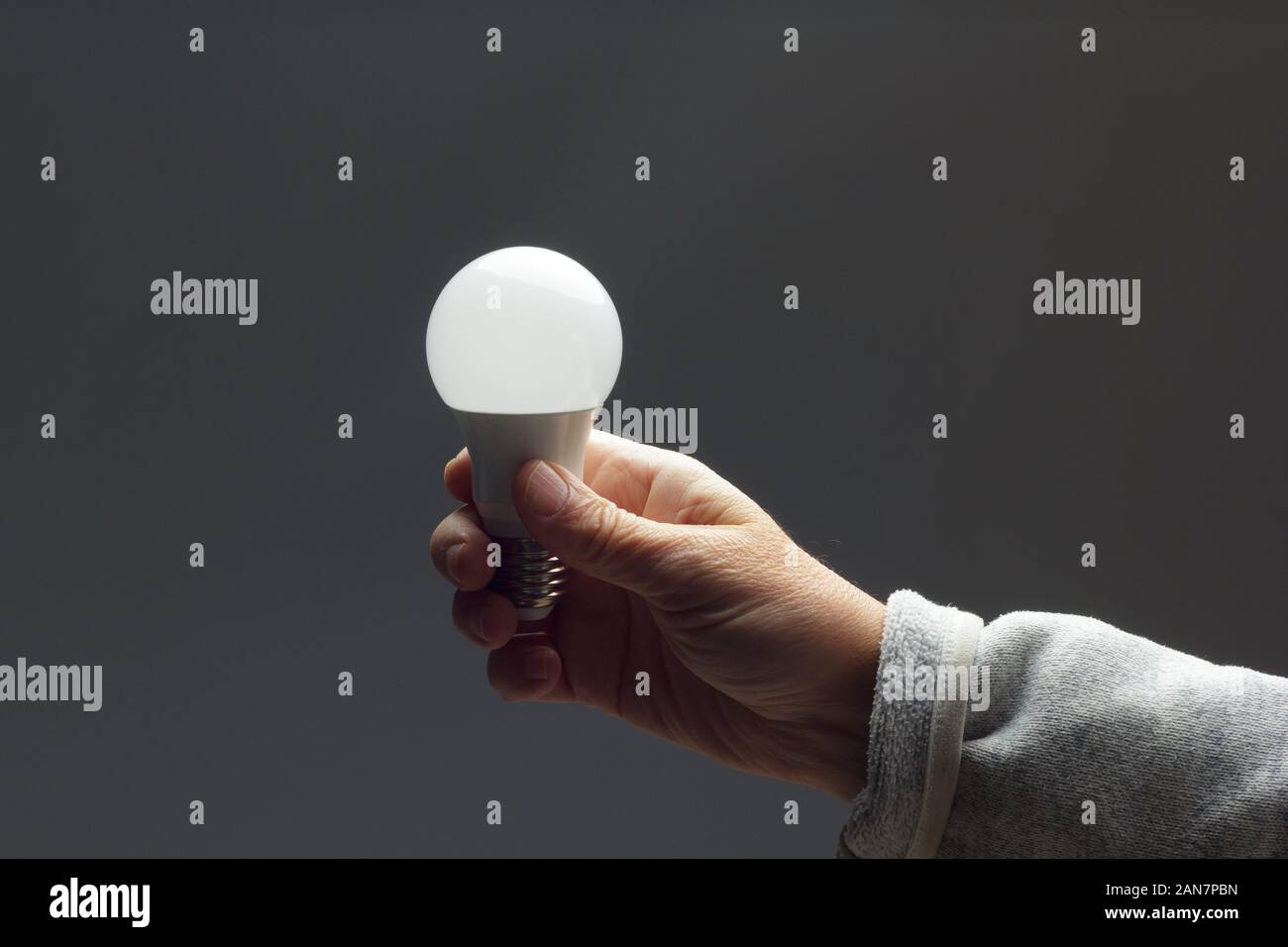 Energy saving daylight bulb, in the hand of an adult; bulb prepared to
