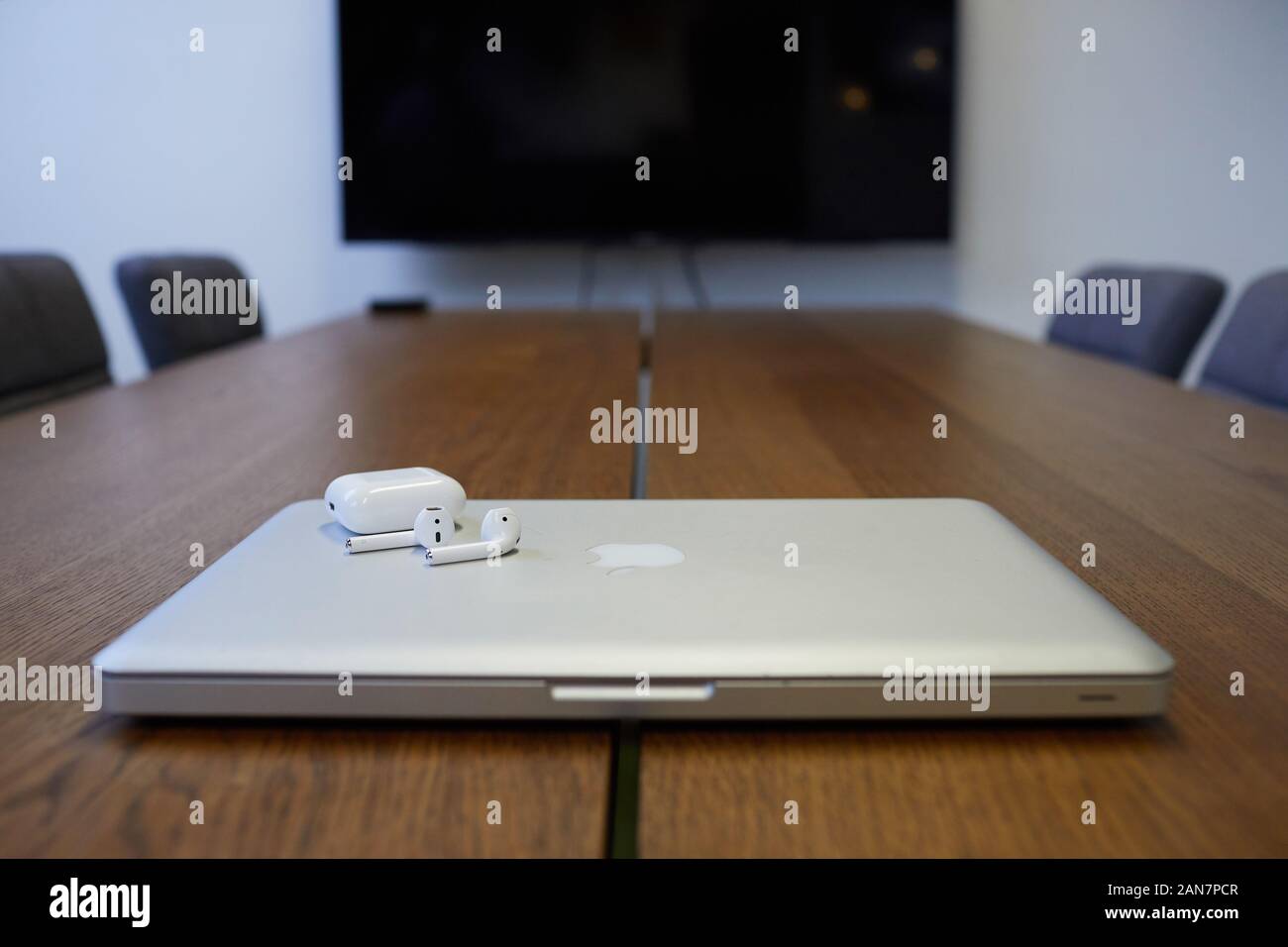 MacBook Pro with Apple EarPods in a board room location Stock Photo - Alamy