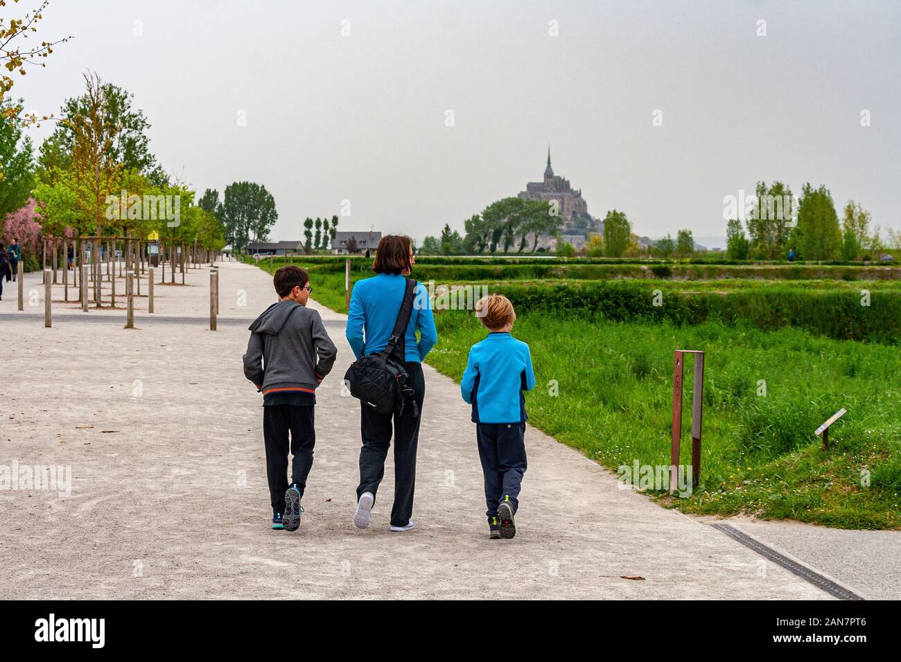 Mother and sons on their way to mont saint michel. Normandy, France Stock Photo