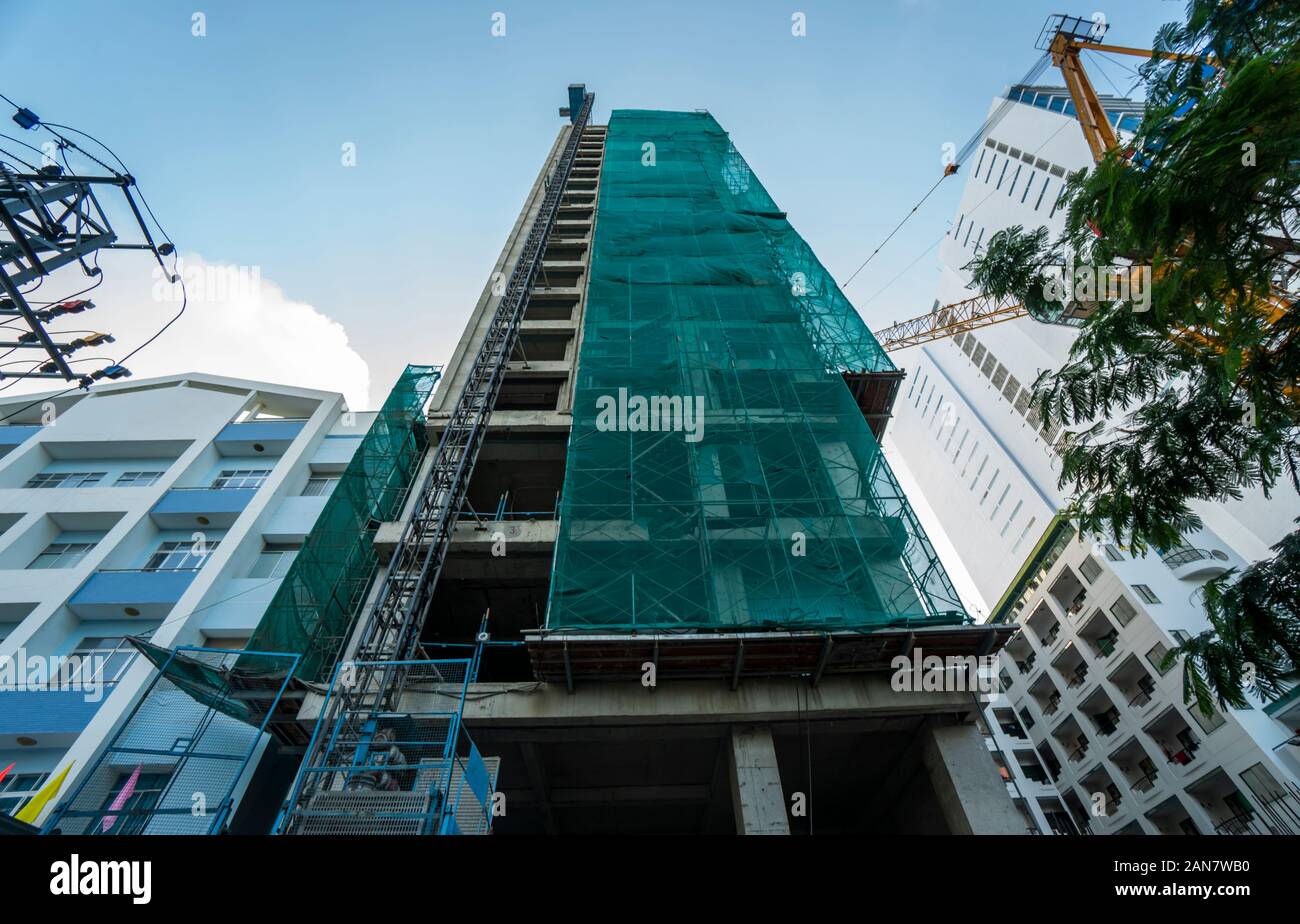 Building construction site against blue sky. Construction of unfinished