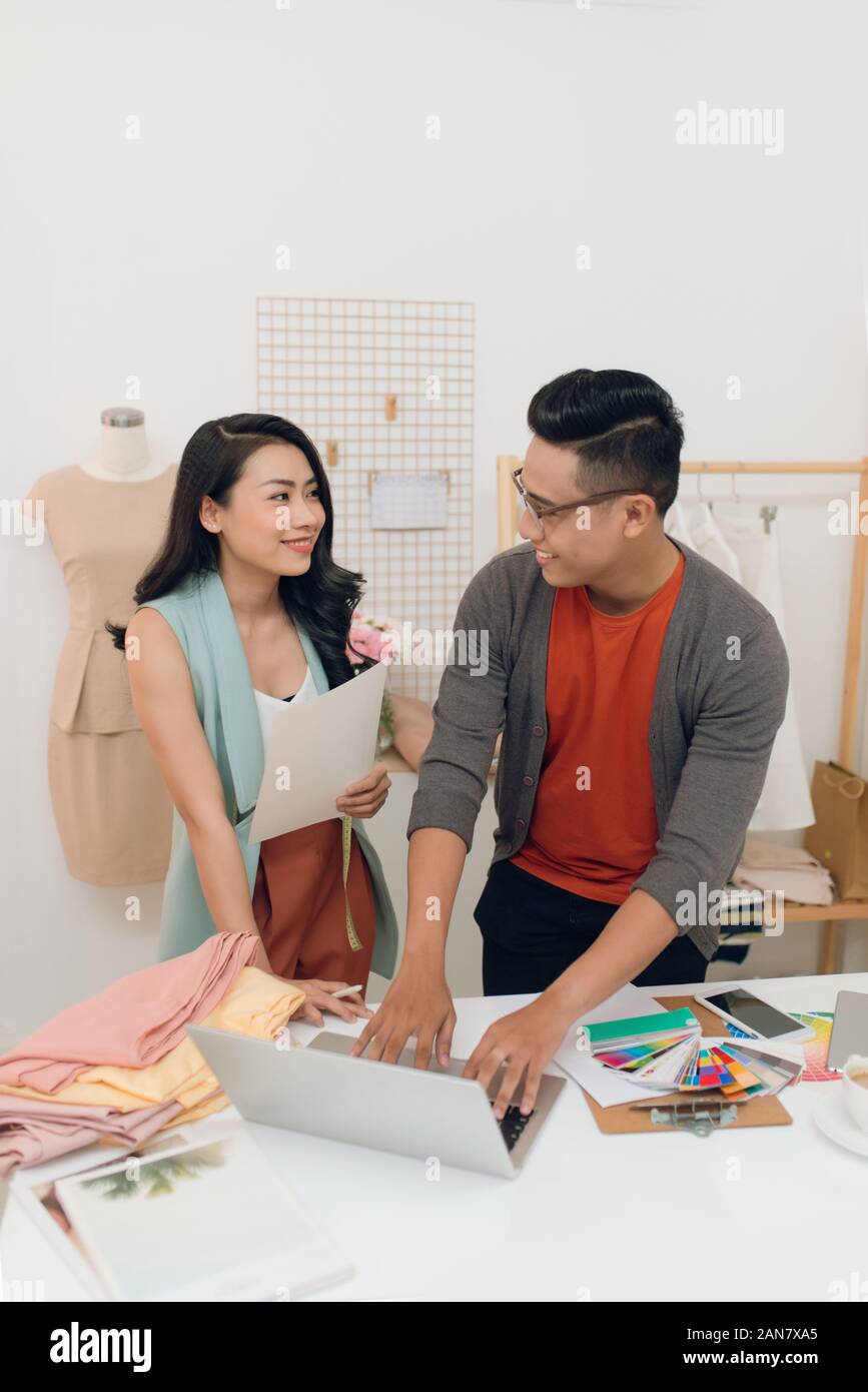 Talking about new fashion design. Beautiful young woman talking with ...