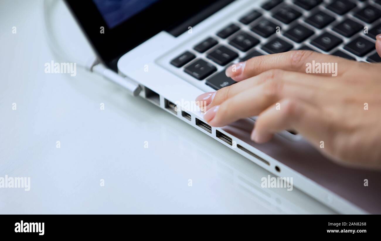 Female hand typing on laptop keyboard, personal computer use at office ...