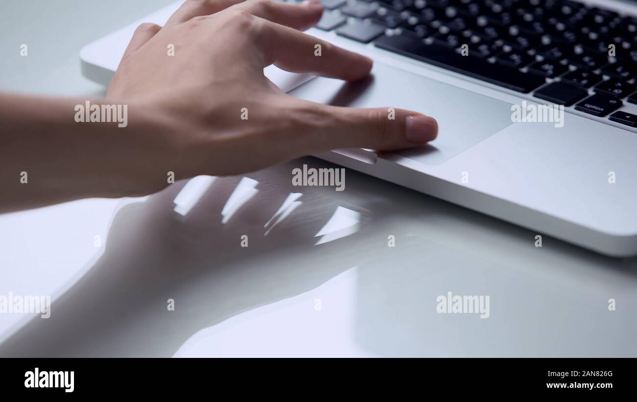 Hand using laptop pc touchpad, personal computer use for work at office or home Stock Photo