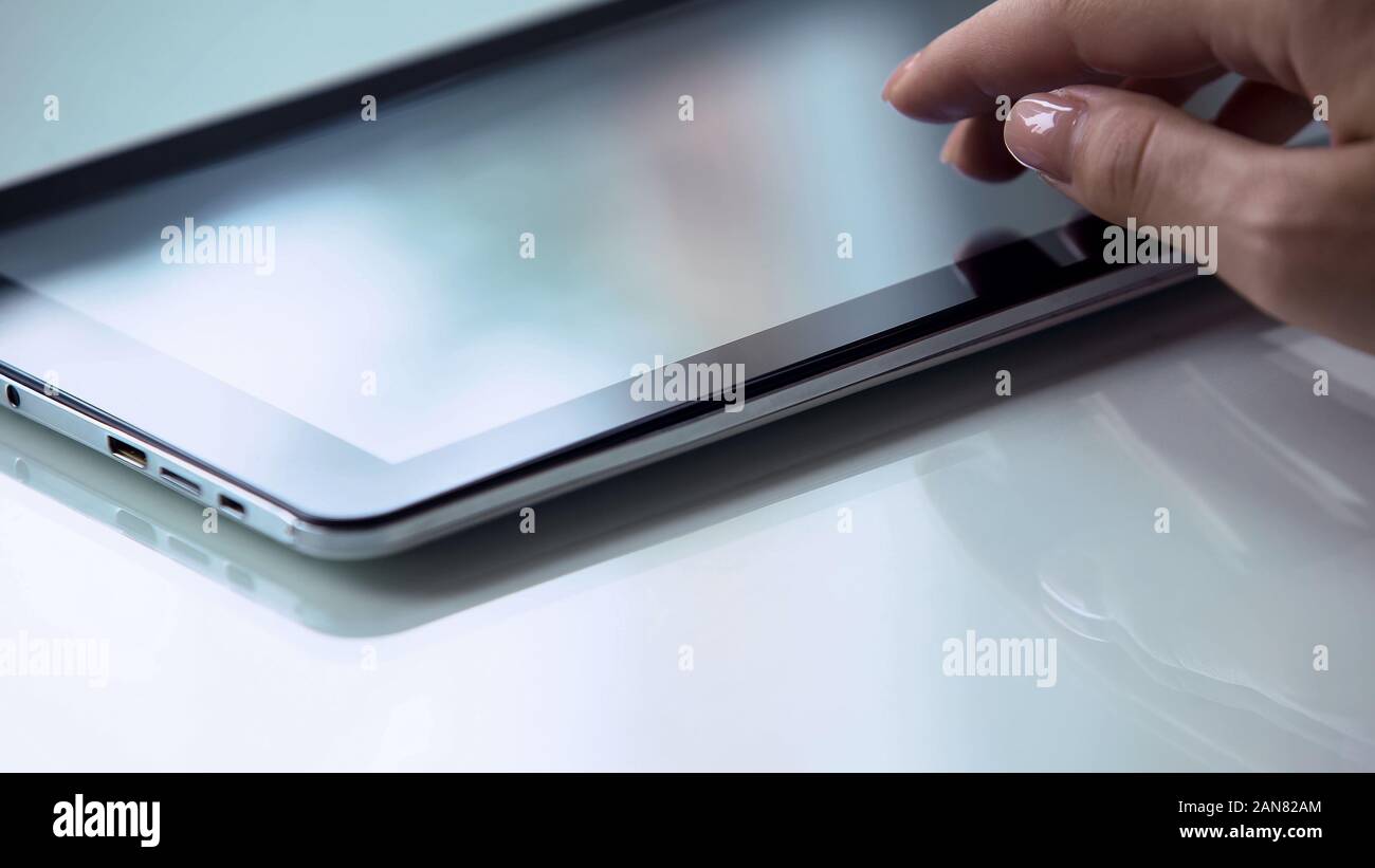 Hand using touchscreen tablet, modern personal computer technology ...