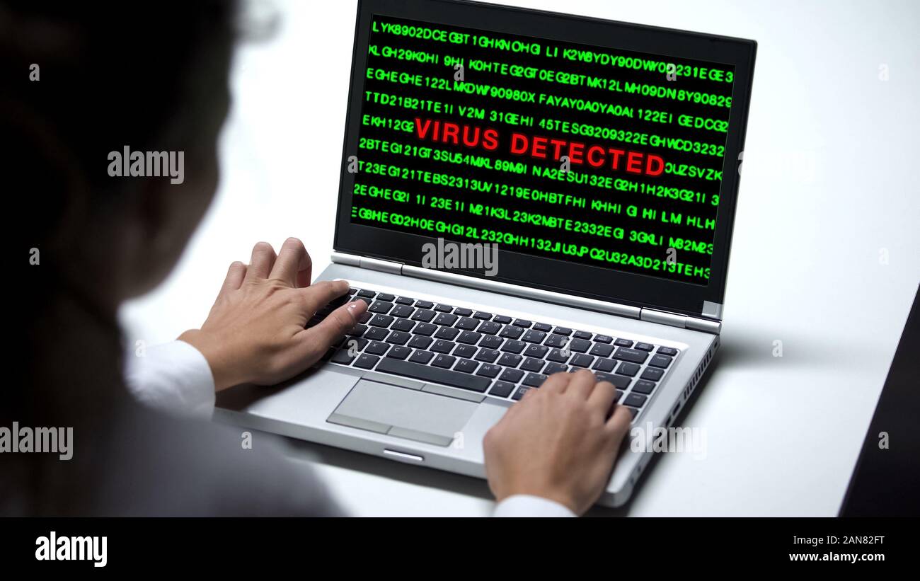 Virus detected on laptop computer, woman working office, cybercrime protection Stock Photo
