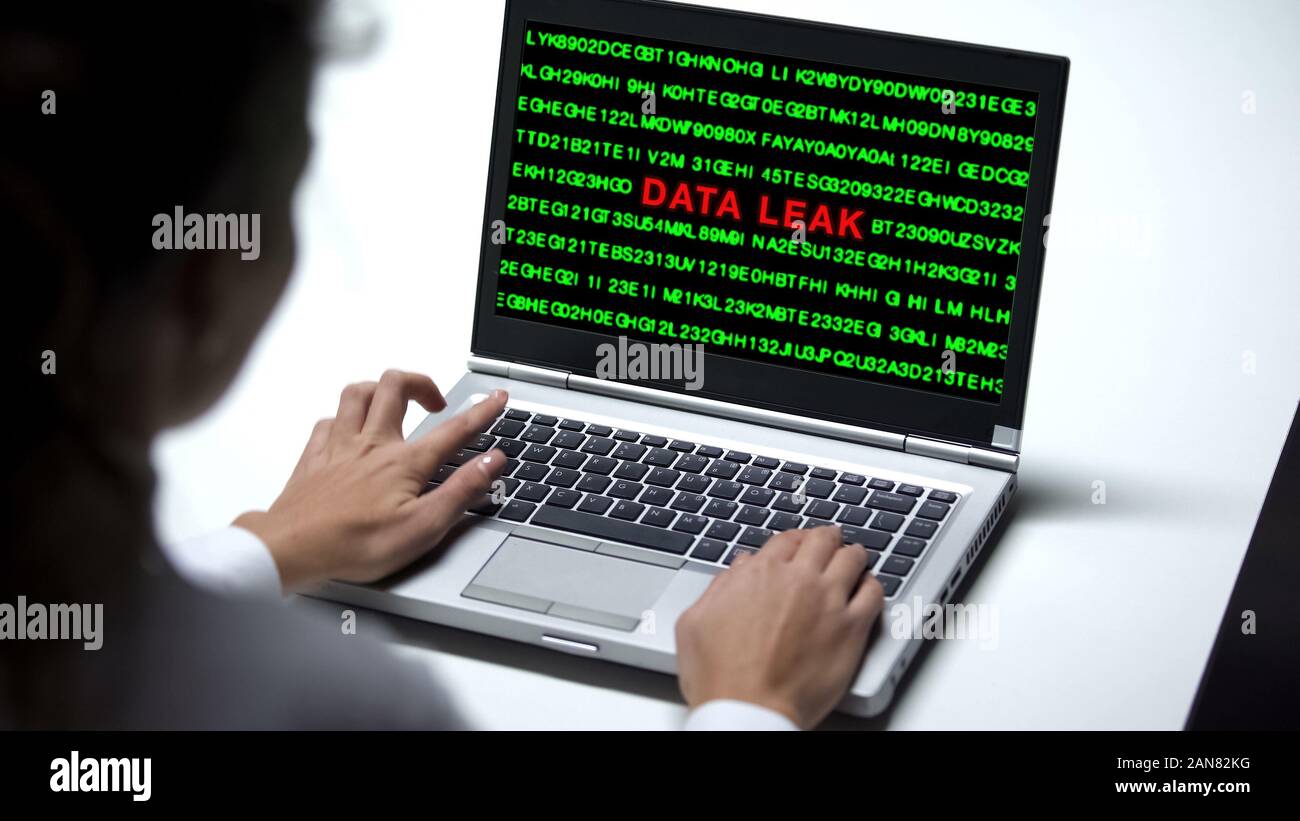 Data leak on laptop computer, woman working in office, cybercrime, close up Stock Photo
