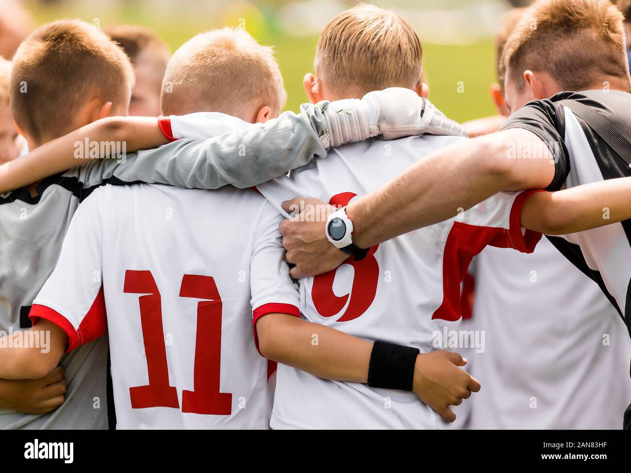 Happy Sporty Kids in a Team. Players in a Team Huddling with Coach Before the Tournament Final Match Stock Photo